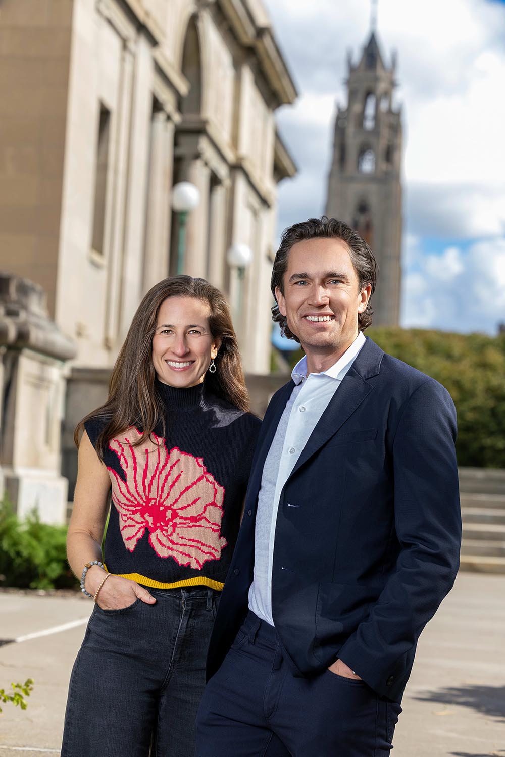 Abby and Doug Bennett smiling with the Memorial Art Gallery in the background.