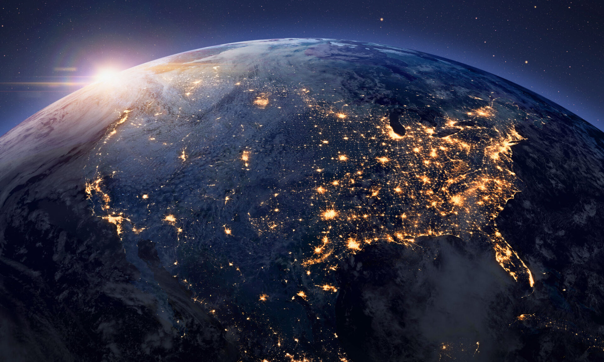 Earth viewed from space at night, illuminated by city lights and natural features across the surface.