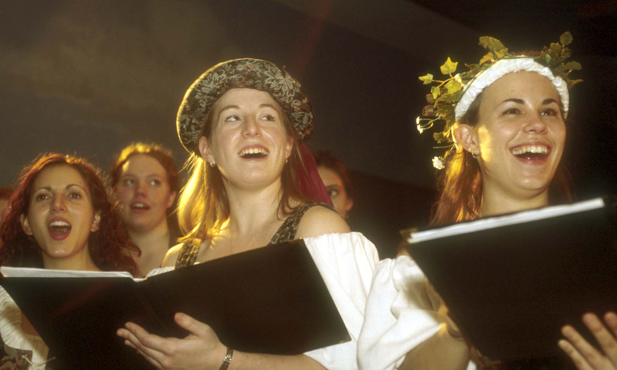 Undergraduates dressed in medieval garb singing in 2002.