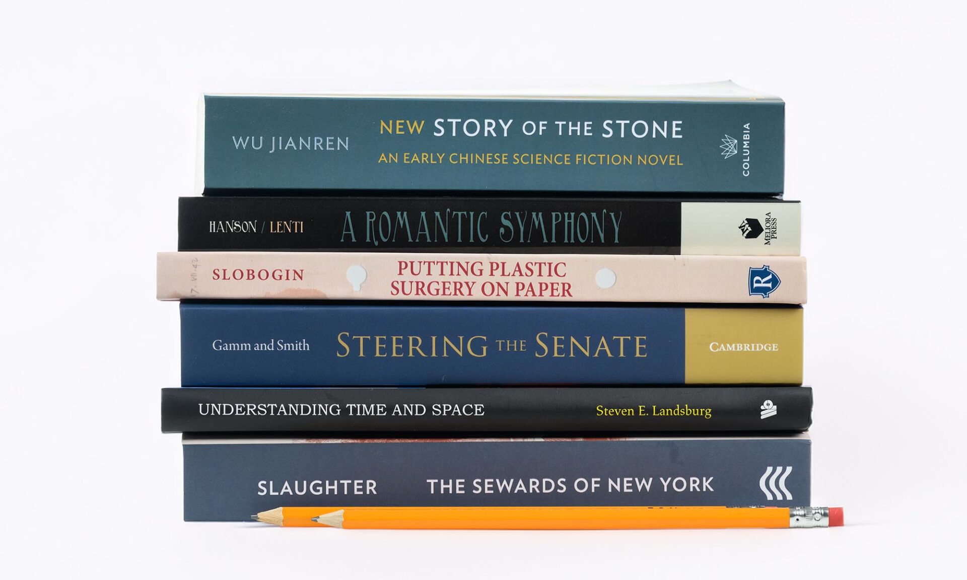 Stack of six books by University of Rochester authors, including Steering the Senate and The Sewards of New York, beside a pencil.
