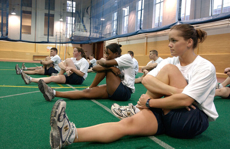 NROTC students stretch in the Goergen Athletic Center during physical training.
