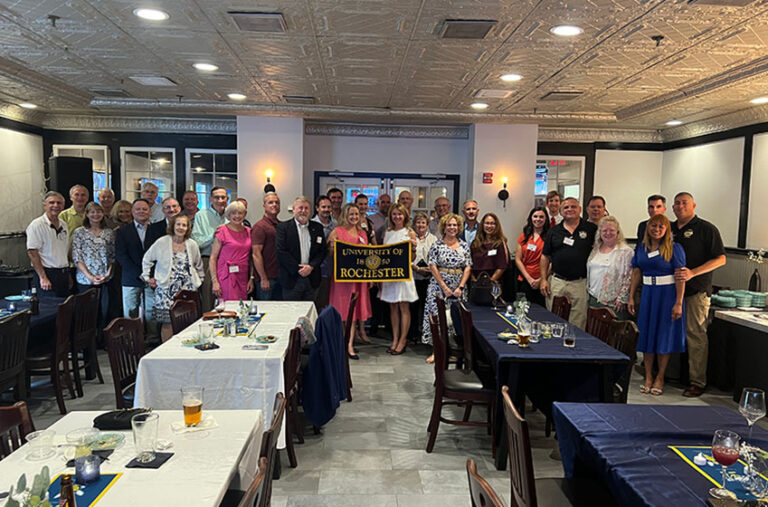 Group shot in an event space of URochester NROTC alumni.
