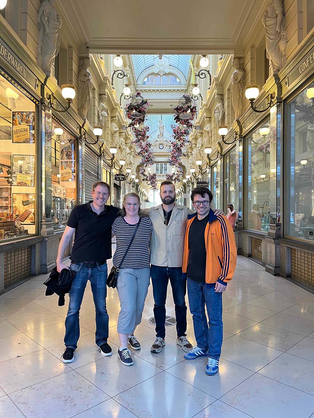 Andreas Maier, Jenny List, Henri Vincenti, and Antonino Di Piazza pose for a group photo in an European arcade. 