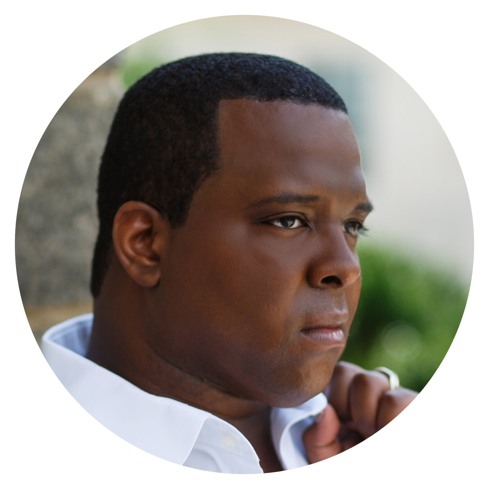 Circle cutout of Joshua Conyers looking off camera.