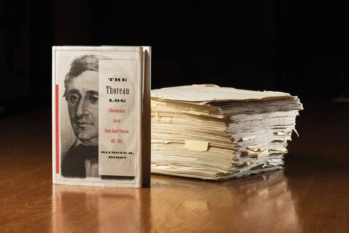 A stack of papers on a table, possibly related to the works of Henry David Thoreau.