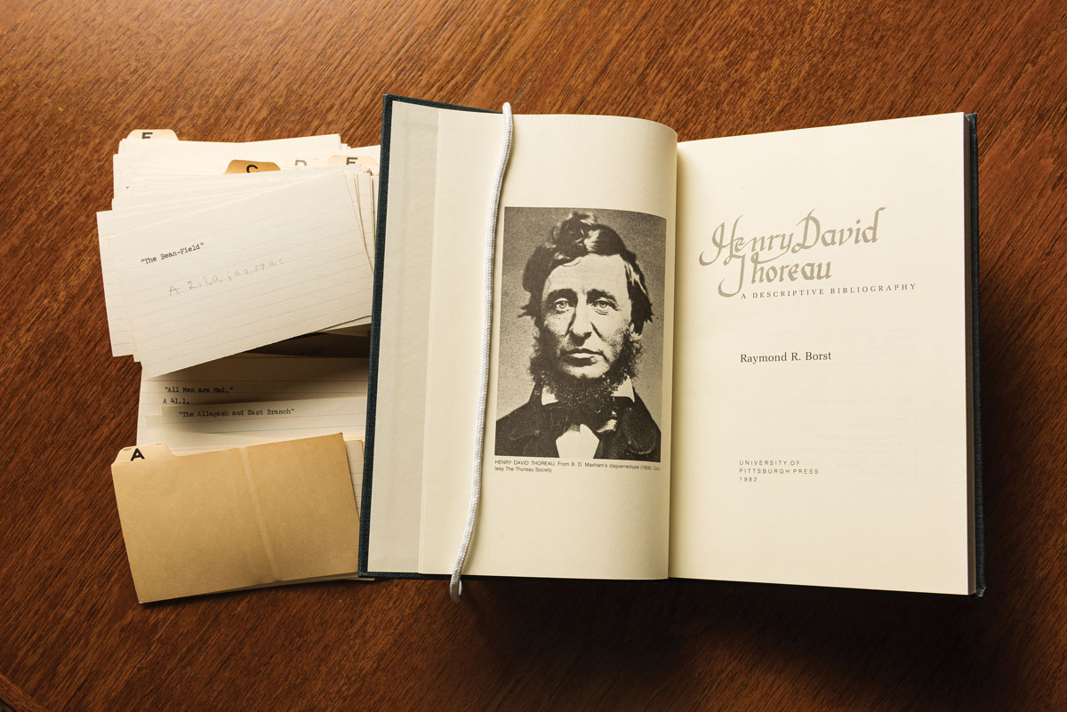 Stack of Mr. Borst’s index cards, left, used in the creation of his landmark work “Henry David Thoreau : a descriptive bibliography” Pittsburgh, PA : University of Pittsburgh Press, 1982 (at right). // Materials from The Raymond R. Borst Collection of Henry David Thoreau in the University of Rochester's Department of Rare Books, Special Collections and Preservation are pictured June 12, 2017.  // photo by J. Adam Fenster / University of Rochester