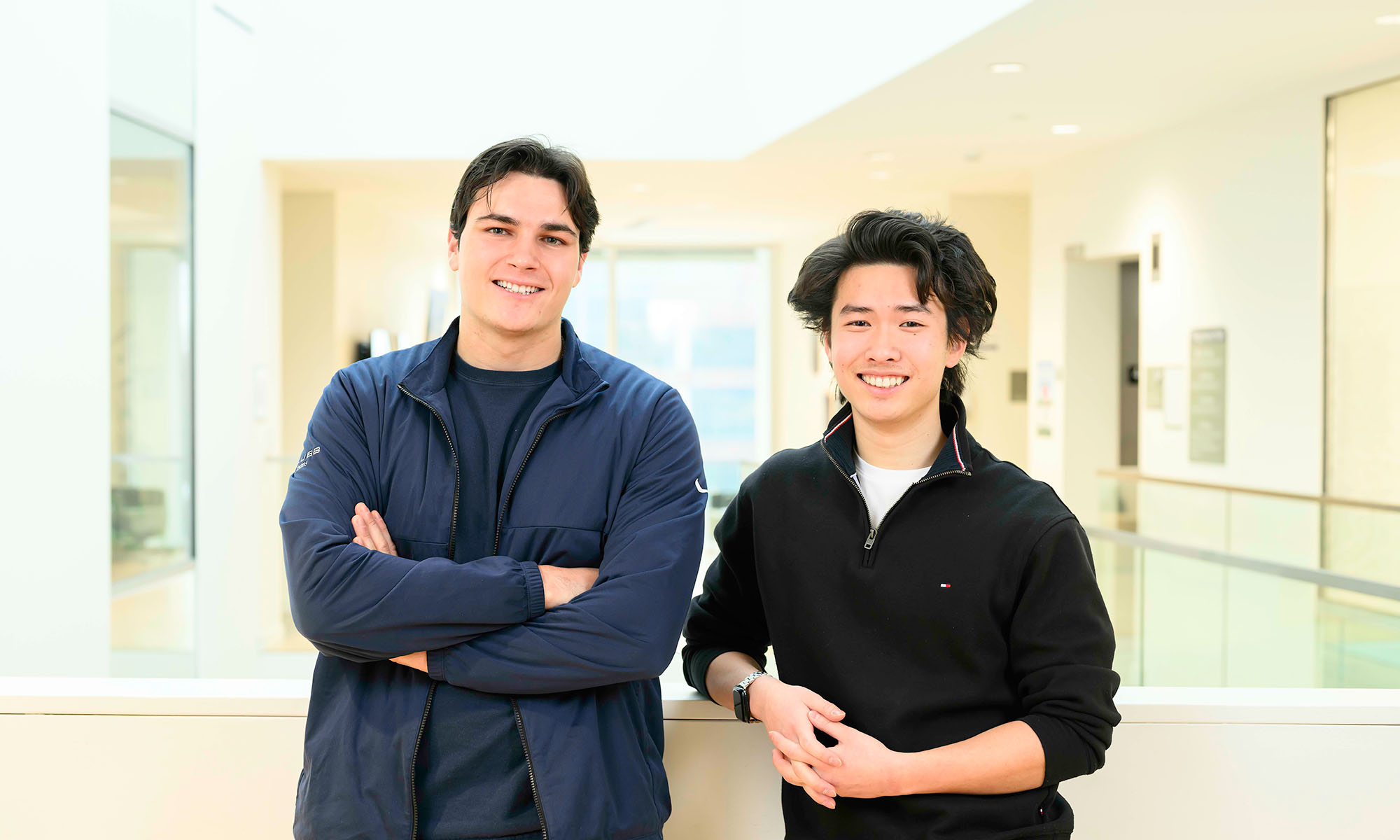 Walter McDonald and Steve Lim smile while standing and facing the camera for a portrait. 