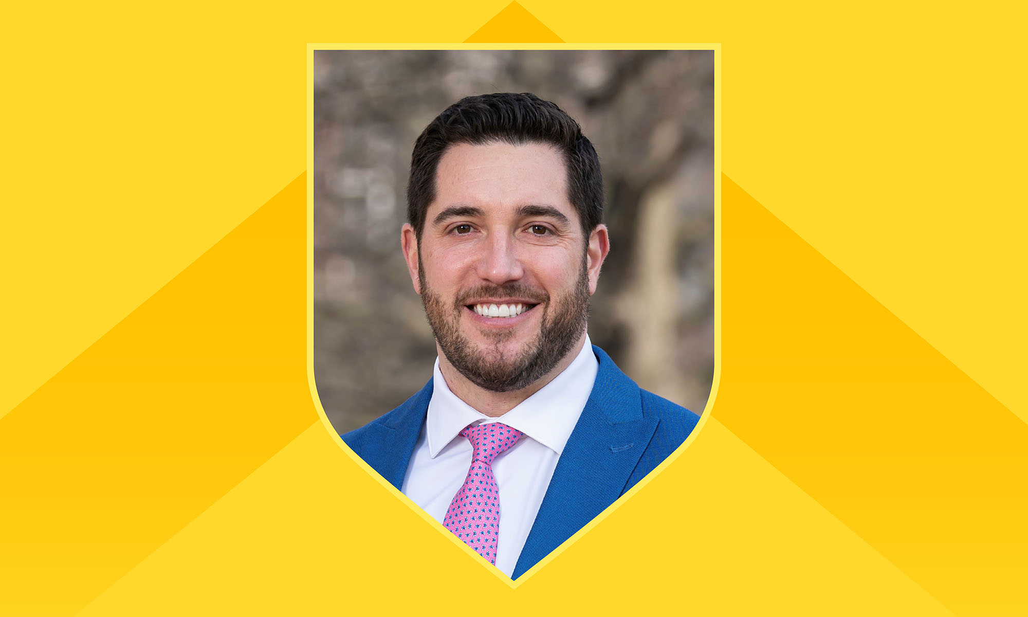 Portrait of Robert Alexander framed within a shield outline against a light yellow background with a darker yellow chevron incorporated.