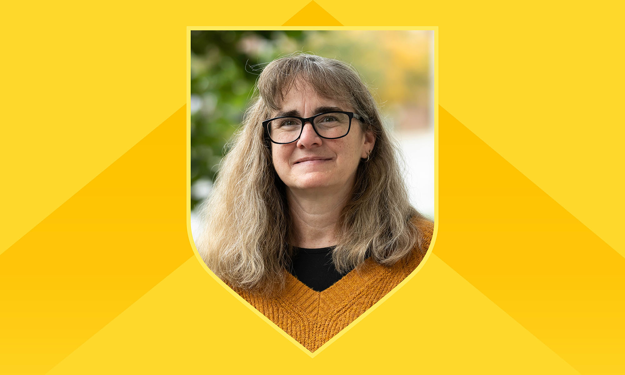 Portrait of Elaine Sia within a shield outline against a yellow background with a darker yellow chevron on it.