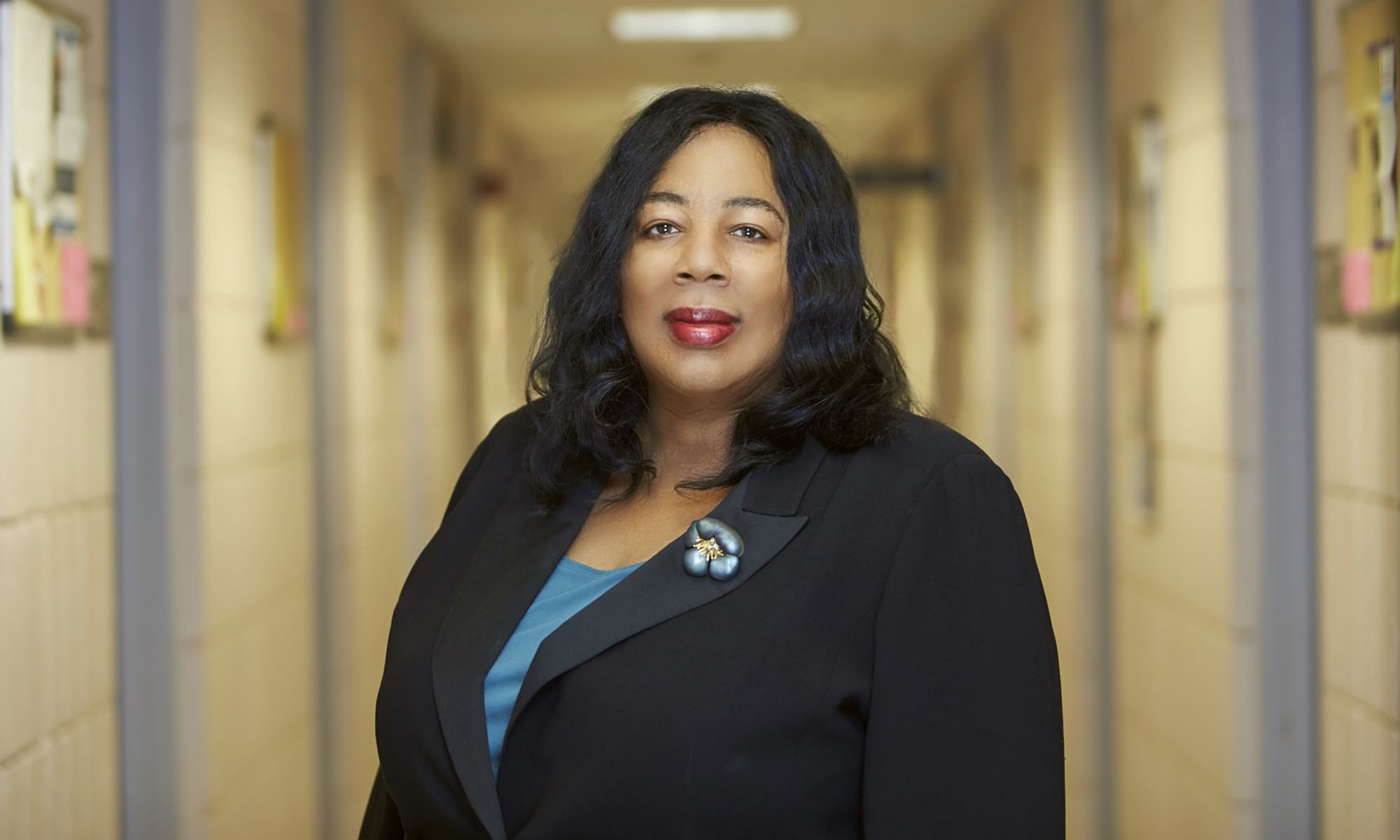 Harriet Washington looking at the camera in a hallway.
