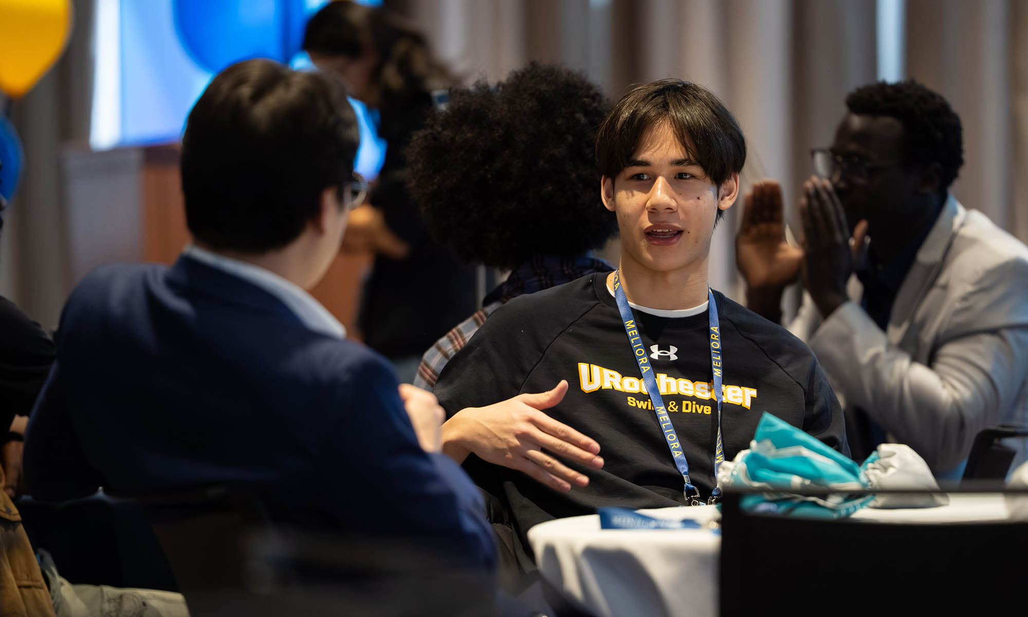 URochester participants conversing at a table during the 2026 Career Exploration Summit.