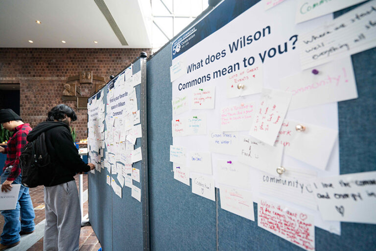Attendees filling out large pieces of paper asking 