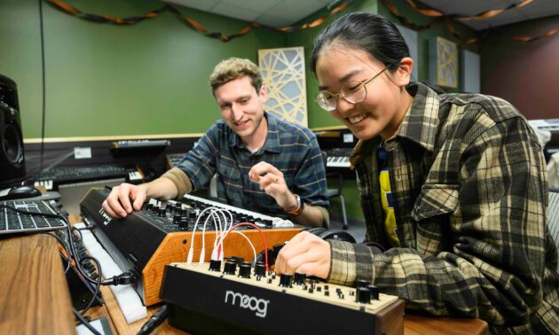 Rick Carl and a URochester undergraduate manipulate a Moog synthesizer.
