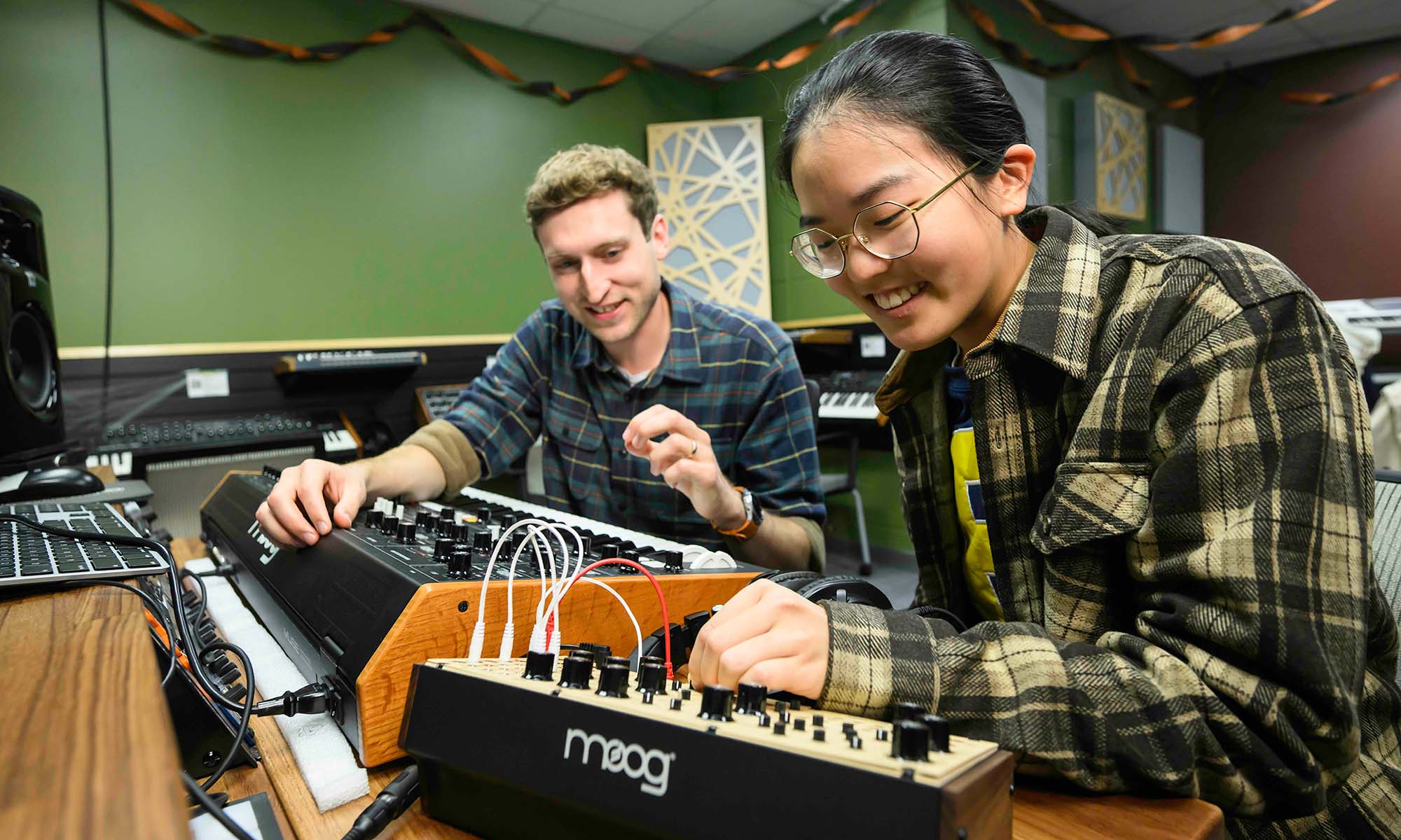 Rick Carl and a URochester undergraduate manipulate a Moog synthesizer.