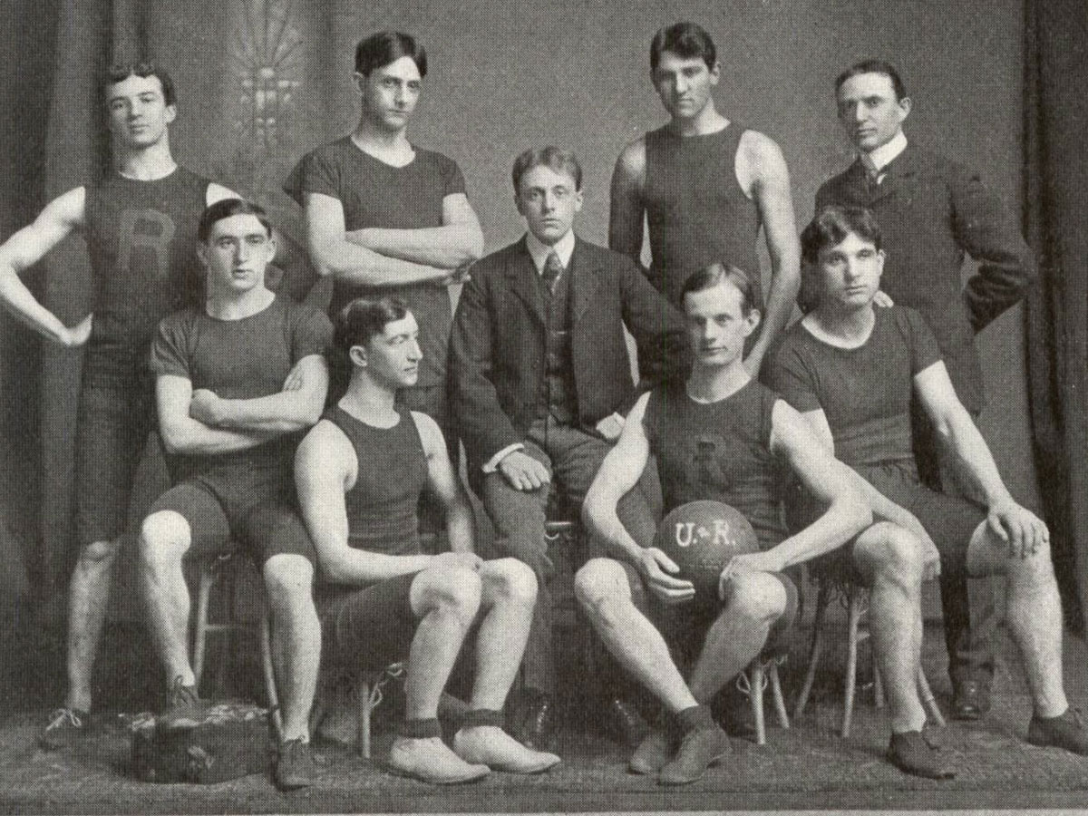 Black and white photo of the University of Rochester basketball team, showcasing players in vintage uniforms.
