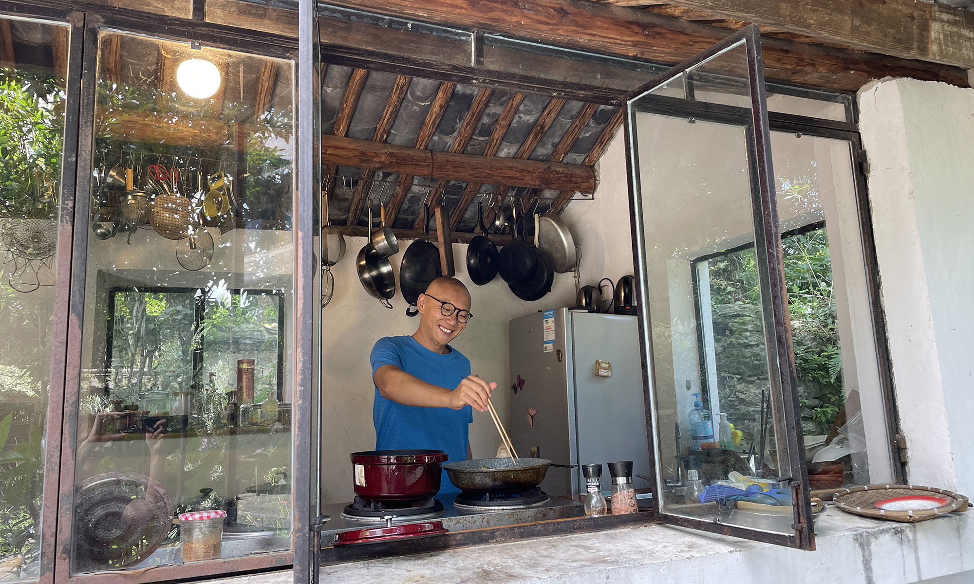Dan Wang stirring a pot on a stove.