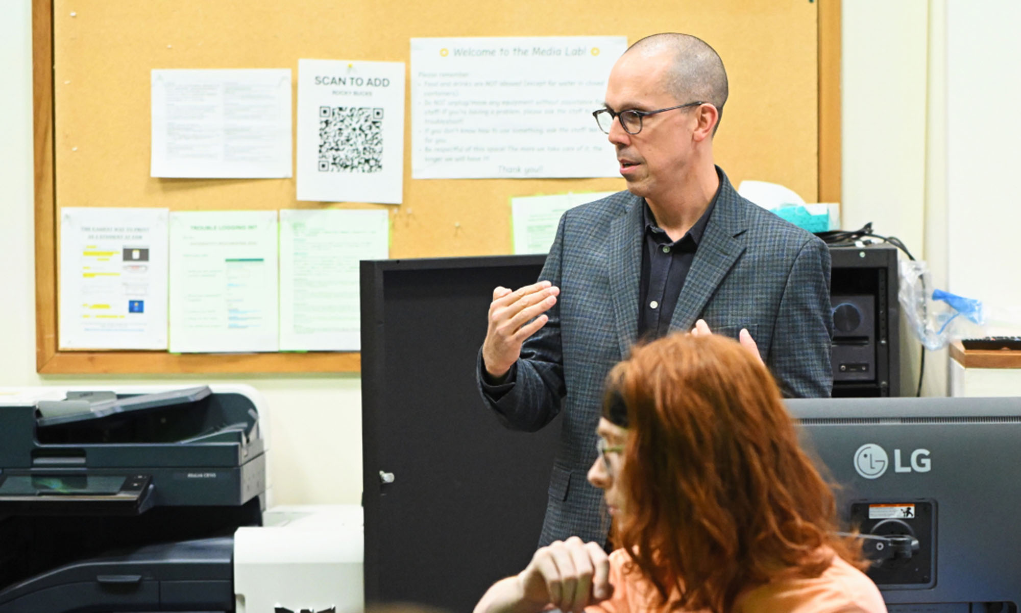 Dennis DeSantis gestures while teaching a class that explores music creation and technology.