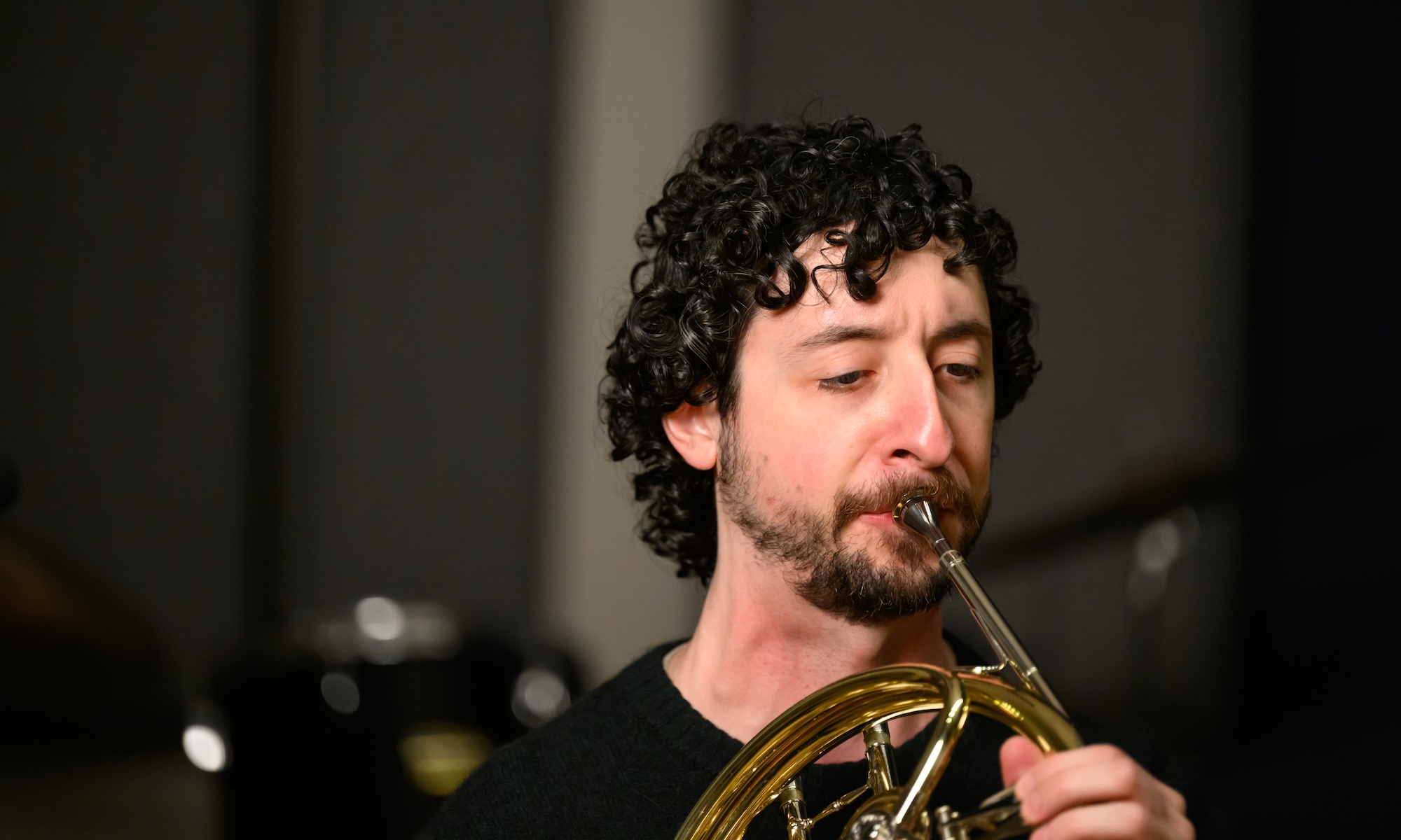 Close up of Jacob Factor, who has the rare throat condition pharyngoceles, playing the French horn.