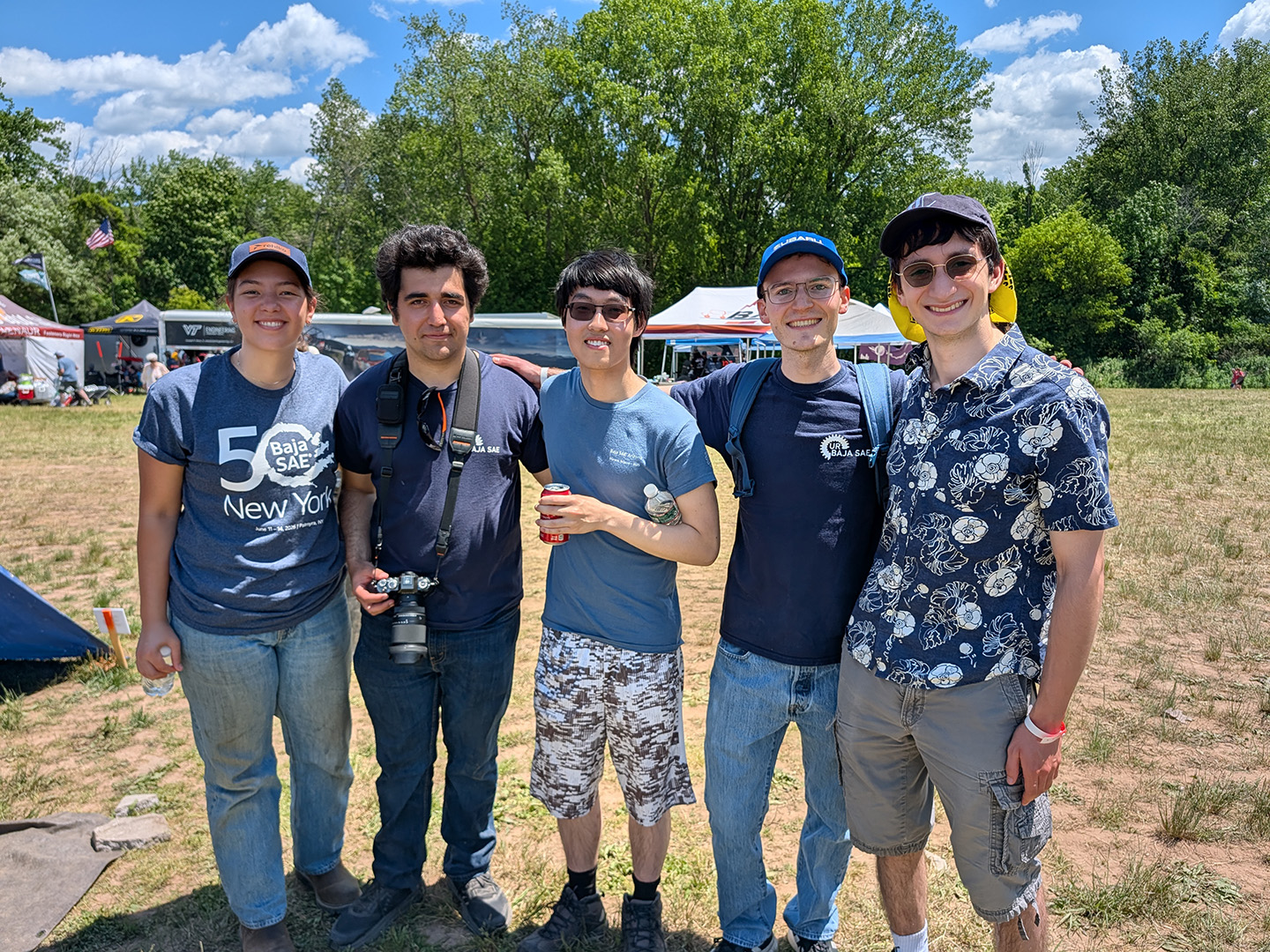 Natalie Shank, Kaan Aytekin, Arthur Chen, Colin Blake, and Jacob Weingard pose for a group photo during the 2026 Baja SAE event.