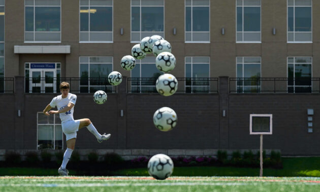 URochester men's soccer team player Johnny Makula curves a soccer ball during a kick to demonstrate the Magnus effect.