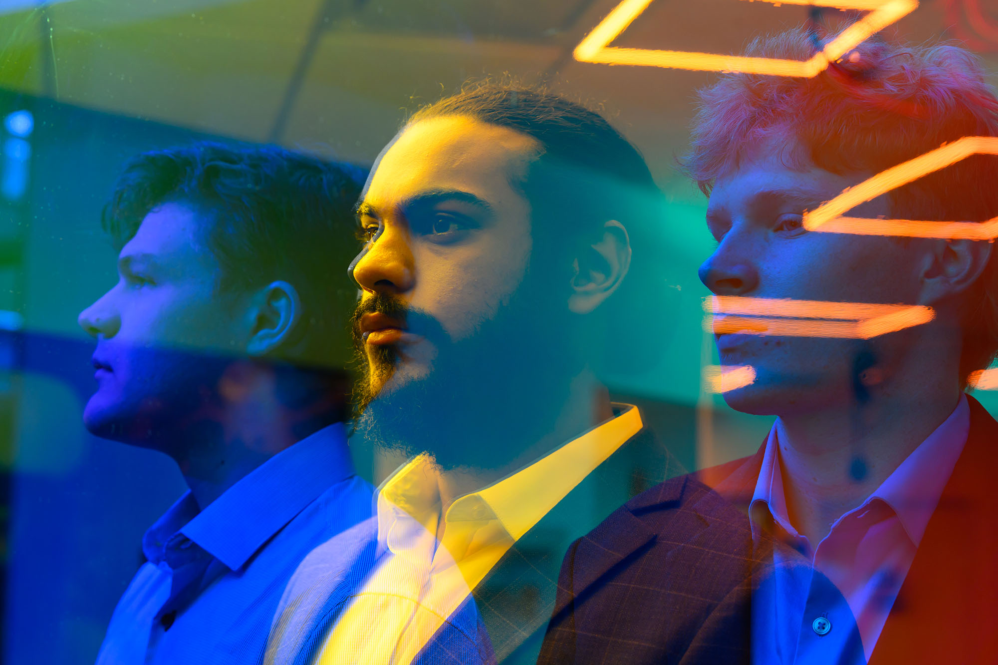 Student entrepreneurs Nate Bogdan, Kohli Guruansh, and Spencer Johnson pose looking off to the left in a futuristic, psychedelic, and colorful treatment.