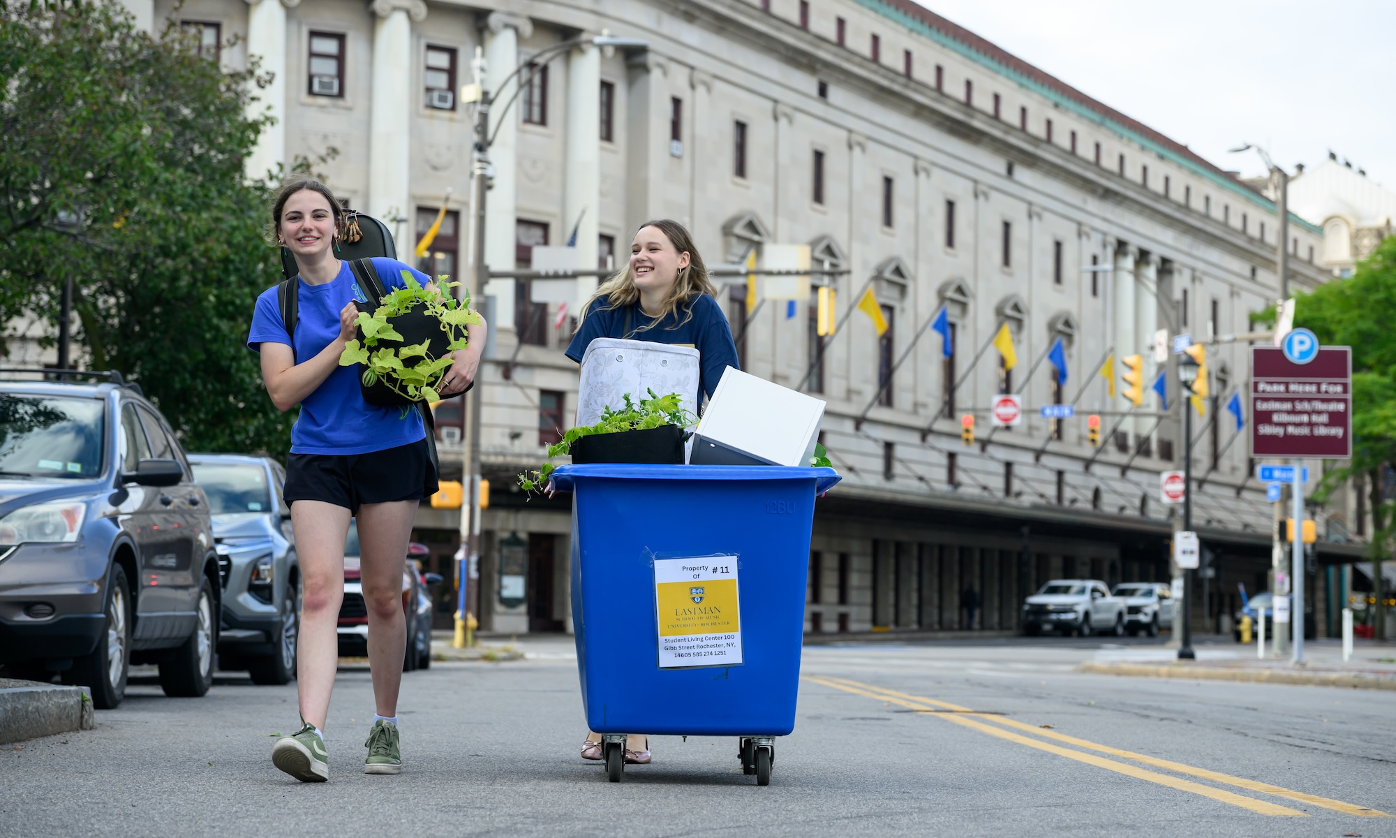 Rory Sandner and orientation leader Donna Hren transport a cart.