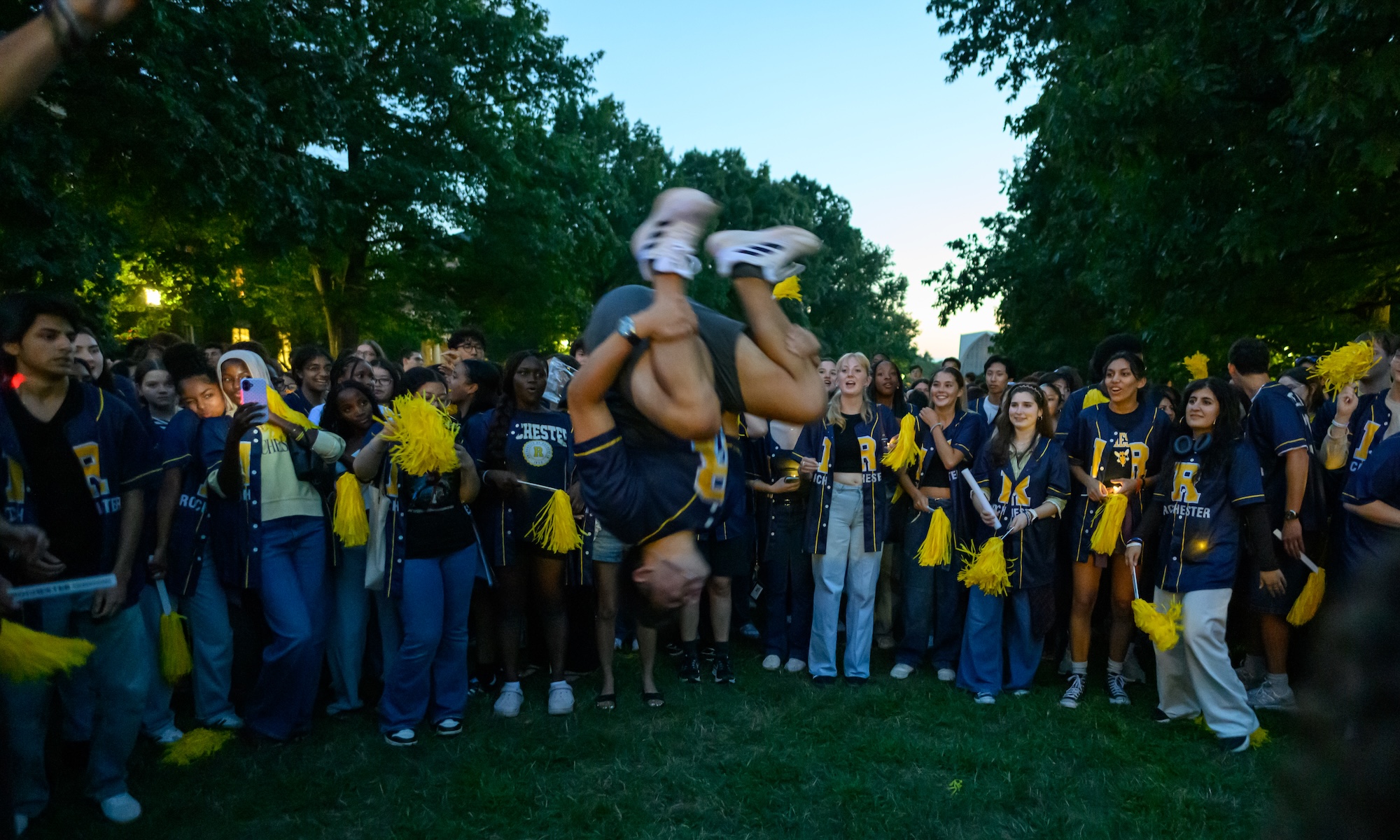 Student performs a backflip during the candlelight ceremony.