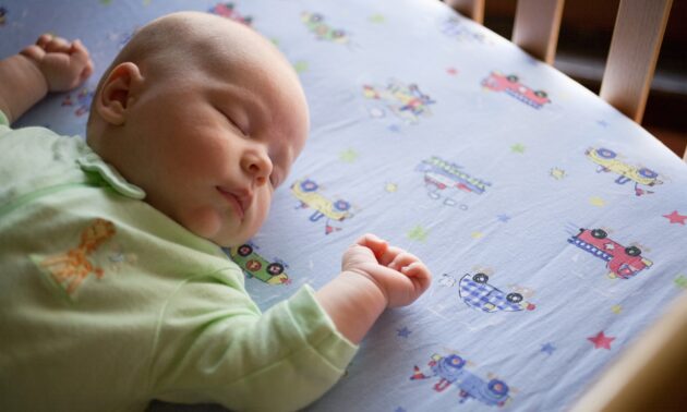 Baby sleeping safely in crib.