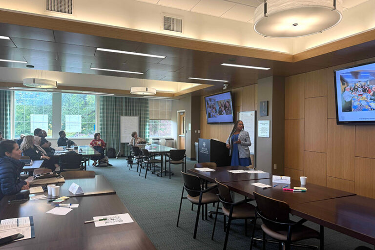A faculty members leads a new student orientation session for incoming Warner School graduate students.