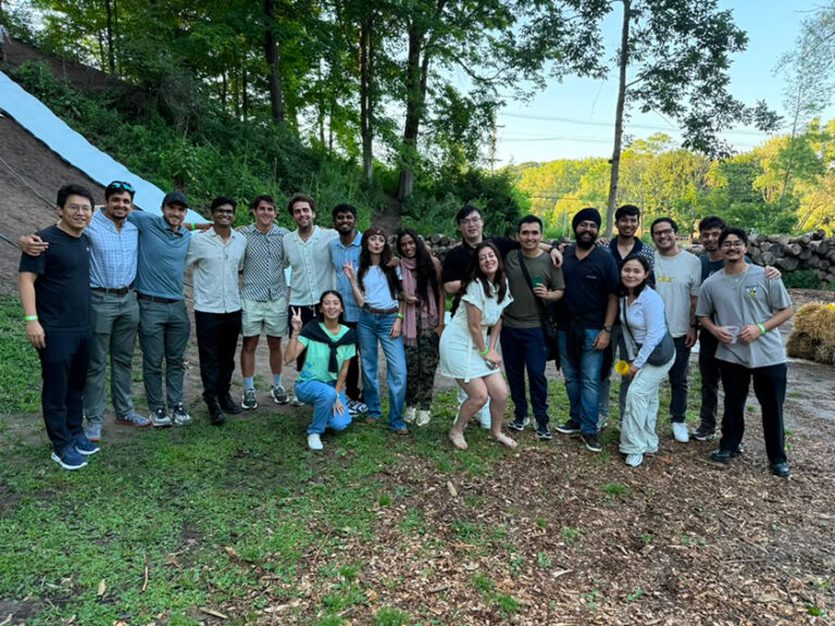 Group photo of Simon Business School MBA students outdoors during an orientation activity.