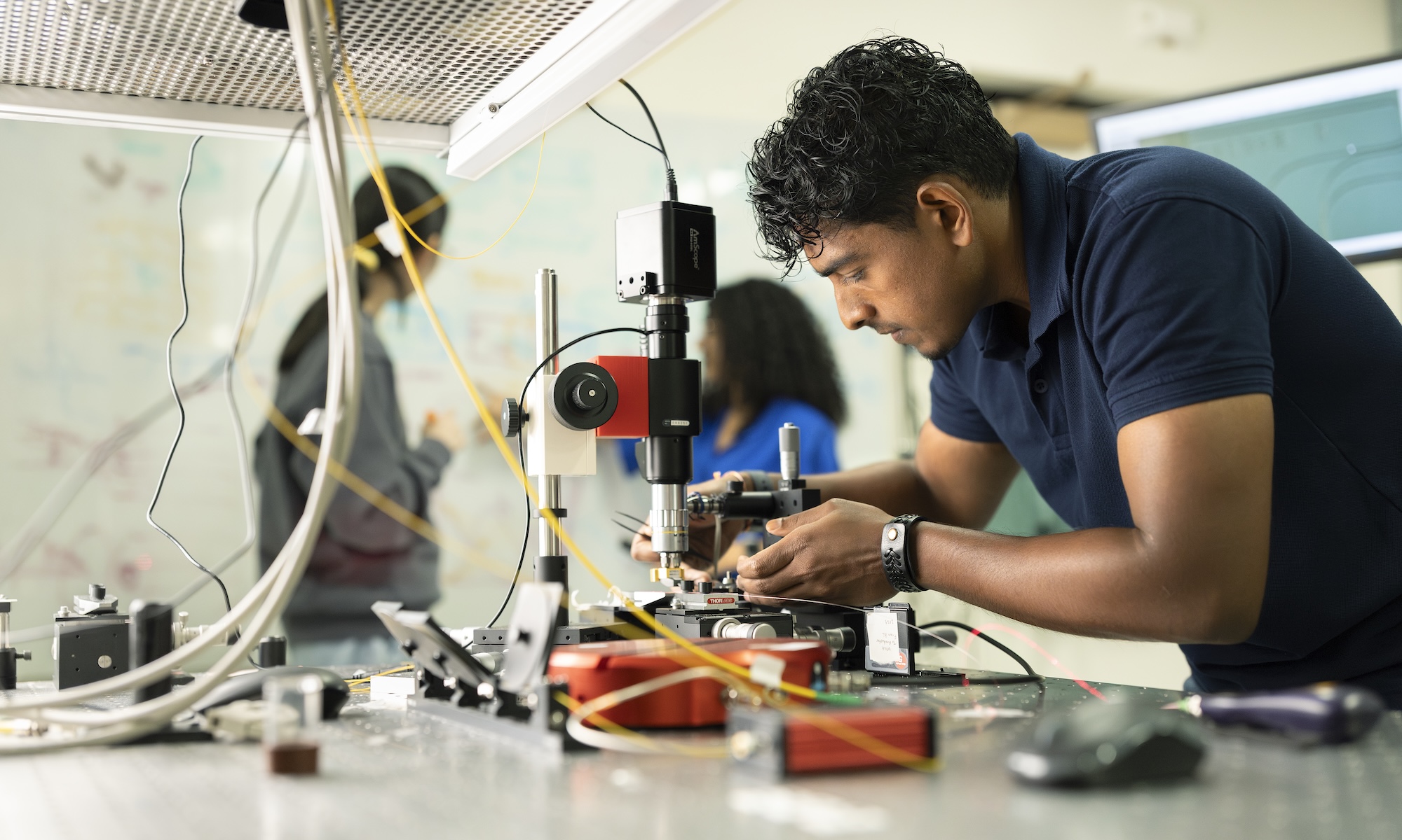 Graduate students conduct research in a URochester lab.