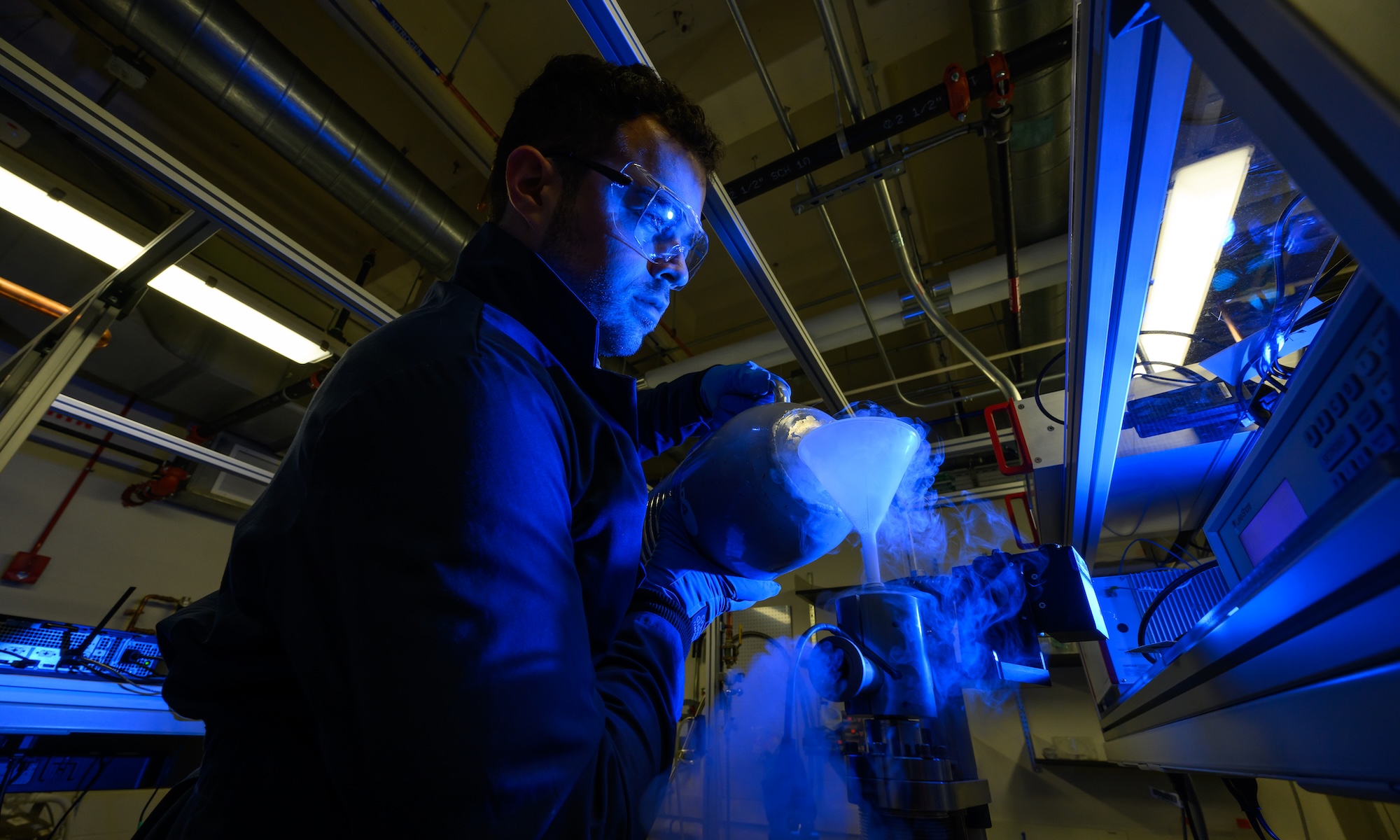 Chemistry PhD Student Alejandro Alvarez pours liquid nitrogen as part of an experiment.