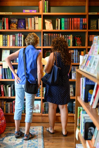 Two women browsing the books at The Siren and the Sea.