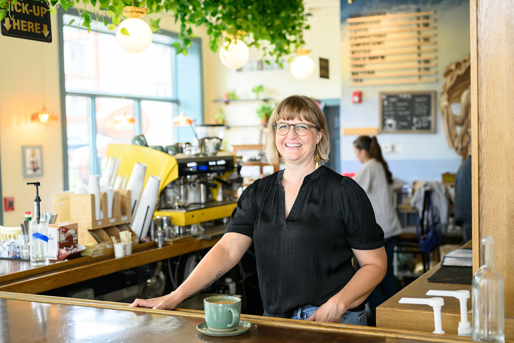 Jess Gale behind the counter of the cafe in The Siren and the Sea.