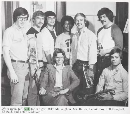 A young Jeff Beal stands at far left with six fellow musicians in a 1982 black-and-white group portrait, several holding brass instruments.