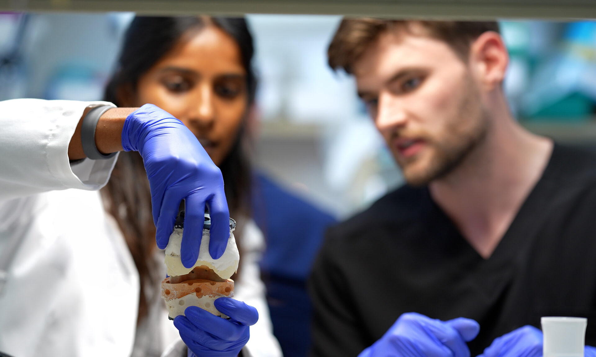 A URochester dentistry faculty member guides a prosthodontics resident through advanced clinical training.