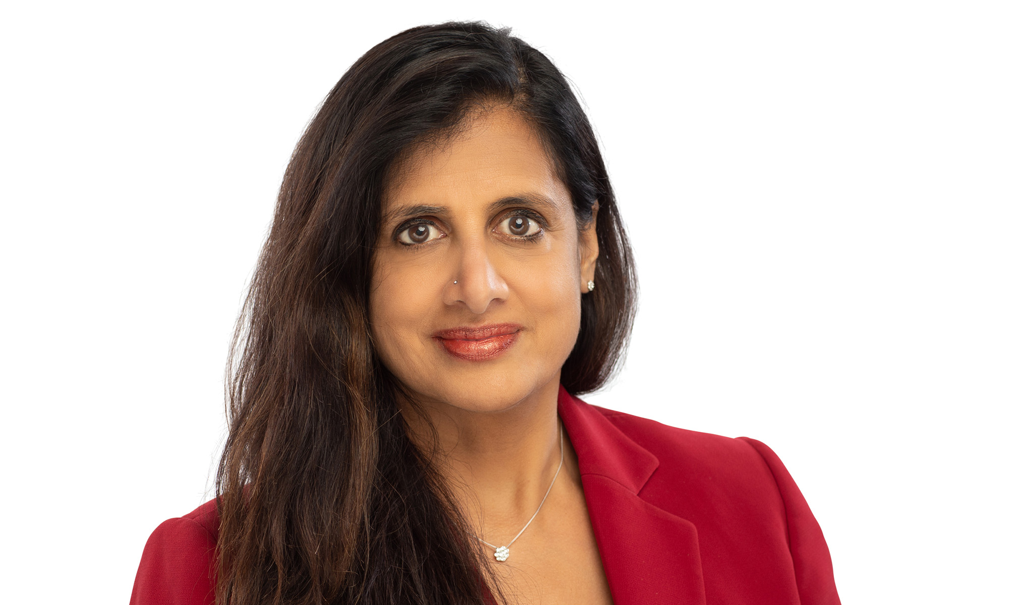 Horizontal crop of a portrait of Sujatha Ramanujan in a red suit against a white background.