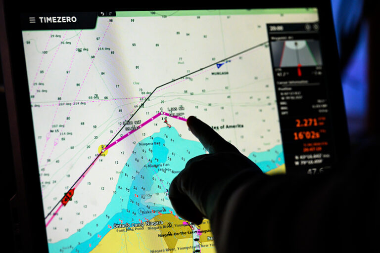 Computer monitor displays a map with colored measurement tracks and methane research data.