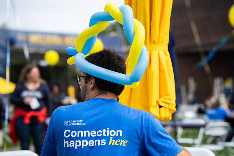 Person seen from behind wearing a blue shirt that says 