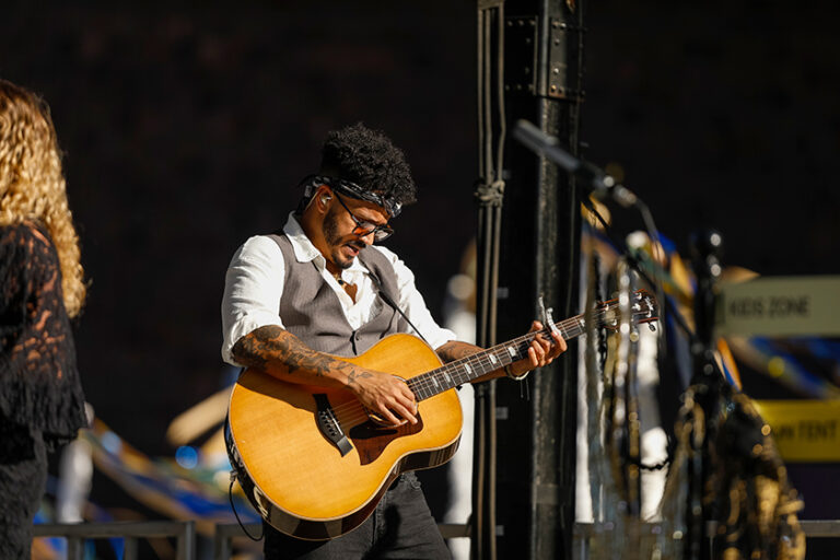 A guitarist from the band The Seven Wonders performs on stage.