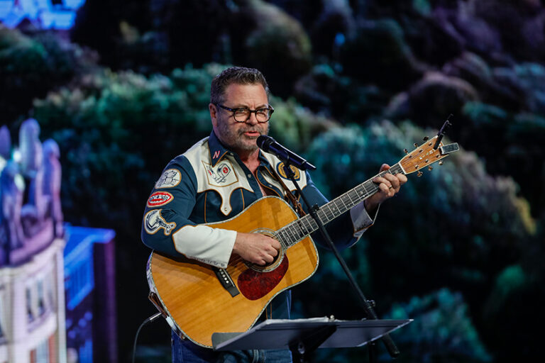 Nick Offerman plays a guitar during his appearance at the University of Rochester for Meliora Weekend 2026.
