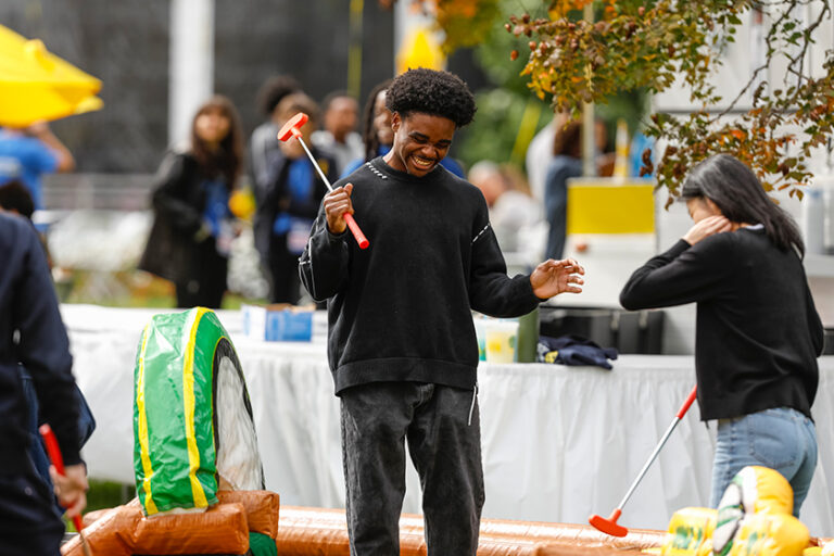 Young male Meliora Weekend attendees experiences the agony of defeat while playing a carnival game.