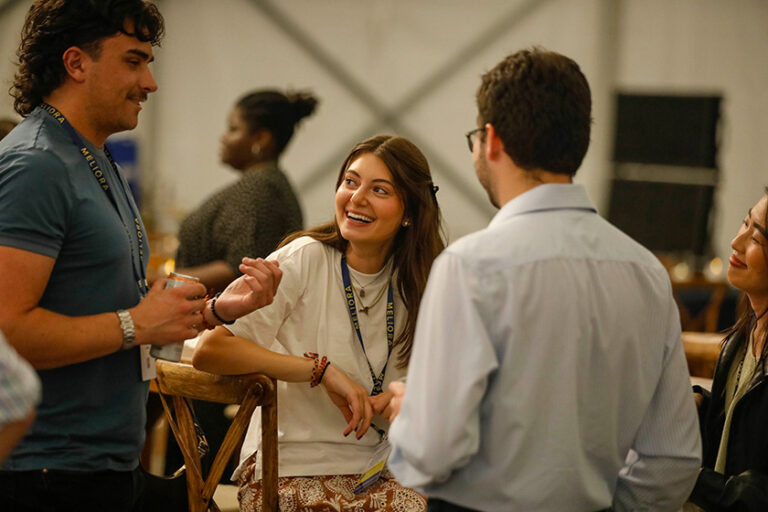 Meliora Weekend 2026 attendees chat in the Meliora Village tent.