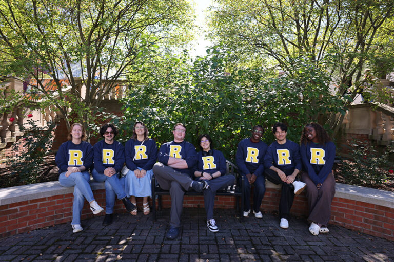A dozen or so University of Rochester seniors sporting their new blue sweatshirts emblazoned with a yellow spirit 