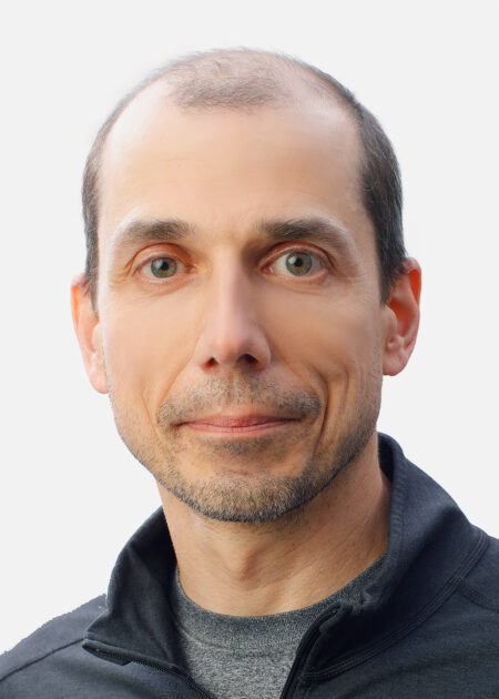 University of Rochester atmospheric chemist Vasilii Petrenko, wearing a dark zip-up jacket, poses against a white background.
