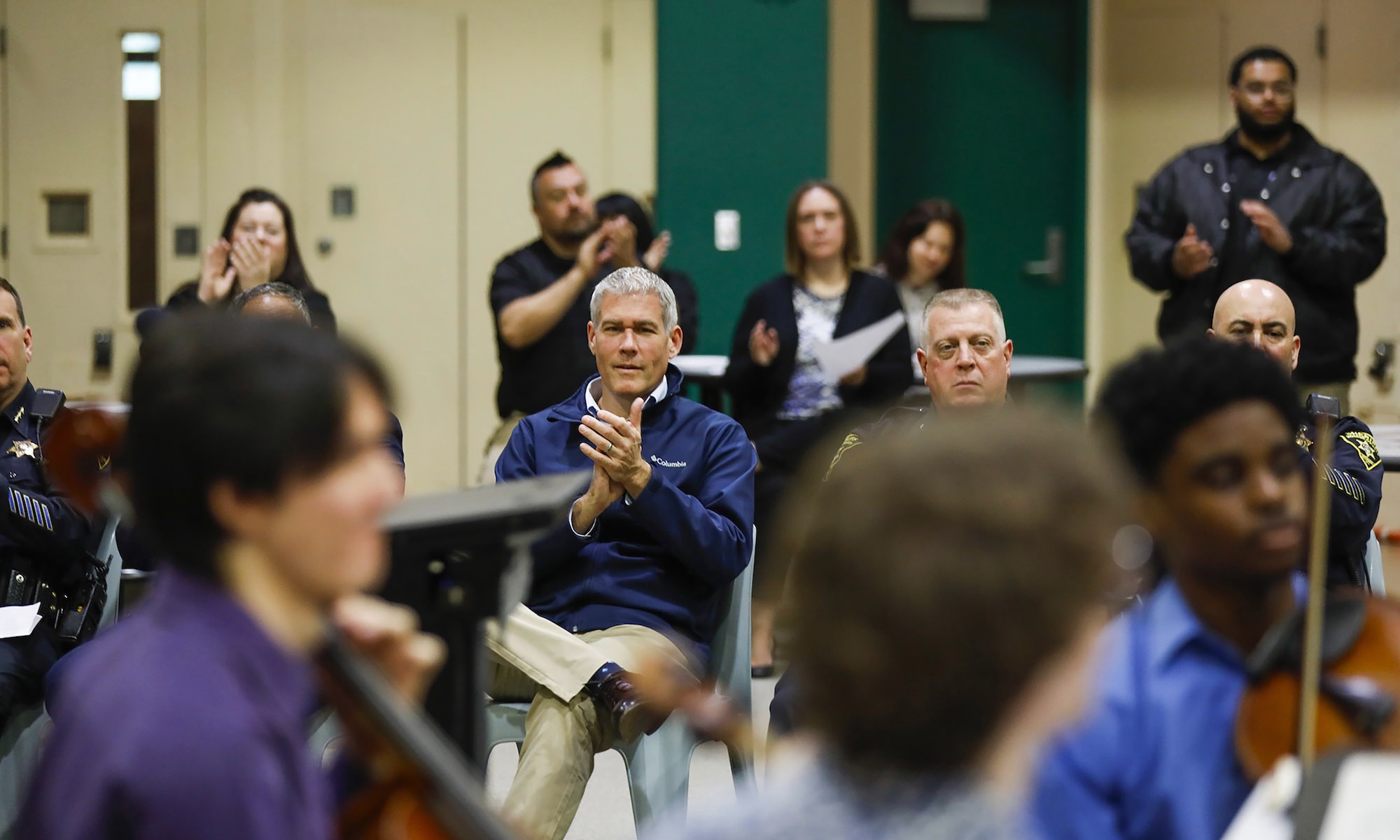 Monroe County Jail staff and County Executive Adam Bello applaud a performance.