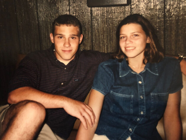 A young Rob Lynch sits beside his future wife, Sarah, with his arm around her shoulders in an archival color photograph.