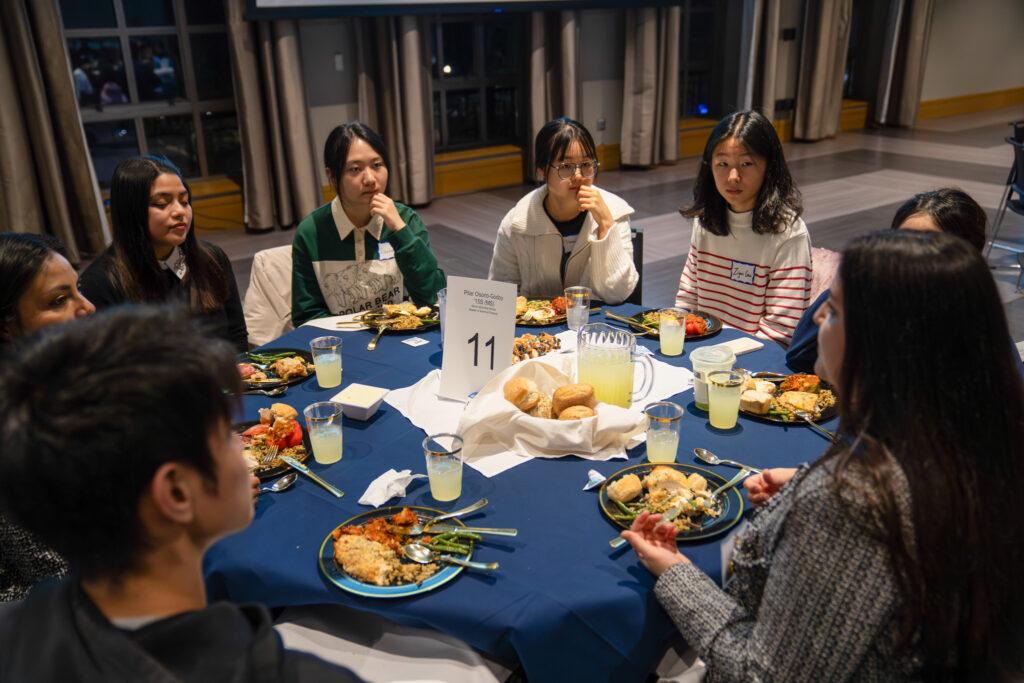 Students at an Etiquette Dinner event sitting at a table chatting