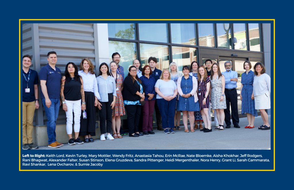 A group photo of 21 members of the International Services Office staff
