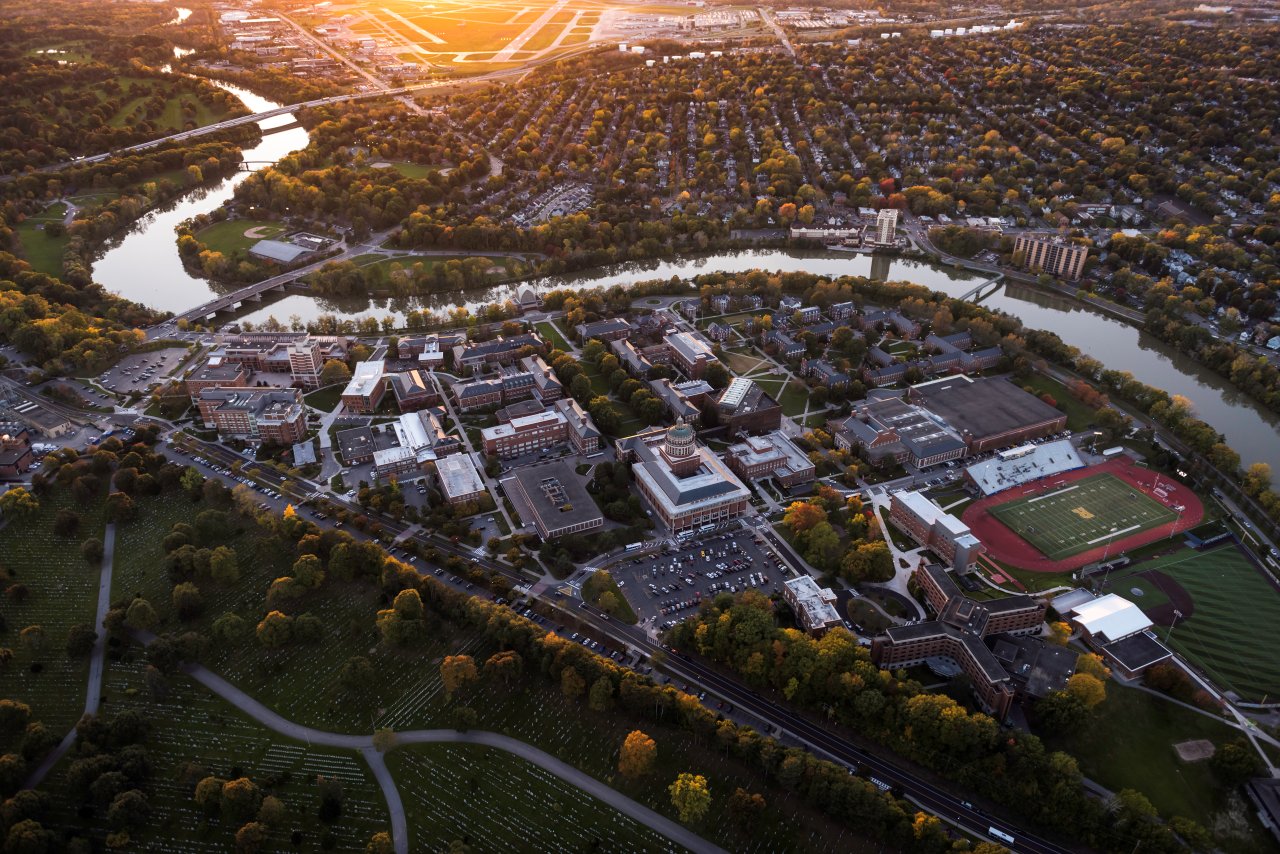 An aerial shot of the University of Rochester campus at sunset, including River Campus and the Medical Center campus